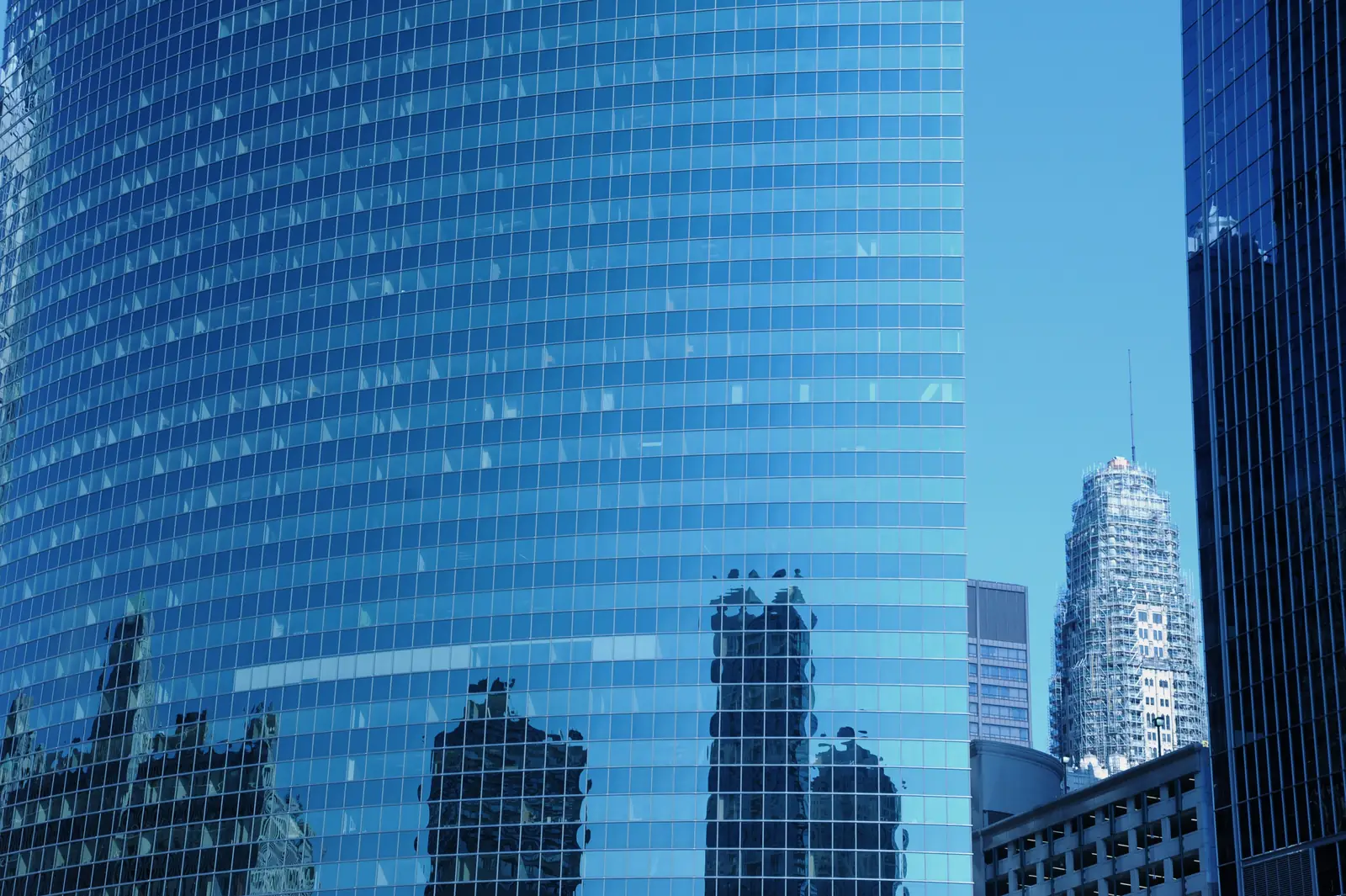 Glass office tower reflecting the sky